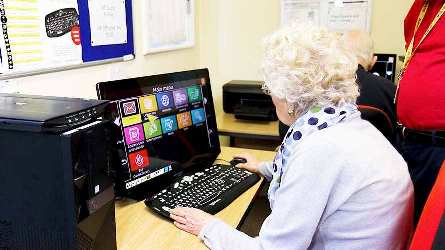 Senior woman using GuideConnect desktop PC.