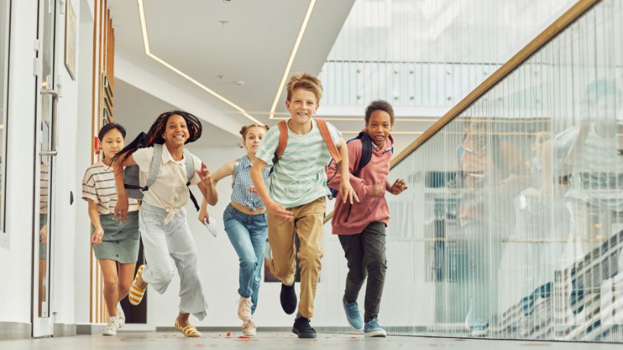 Kids running down a corridor