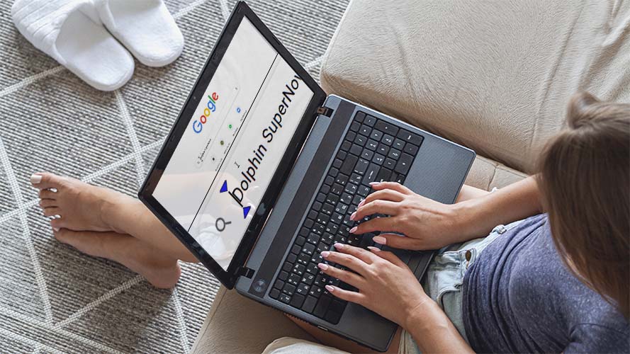 A woman using SuperNova on a laptop at home.